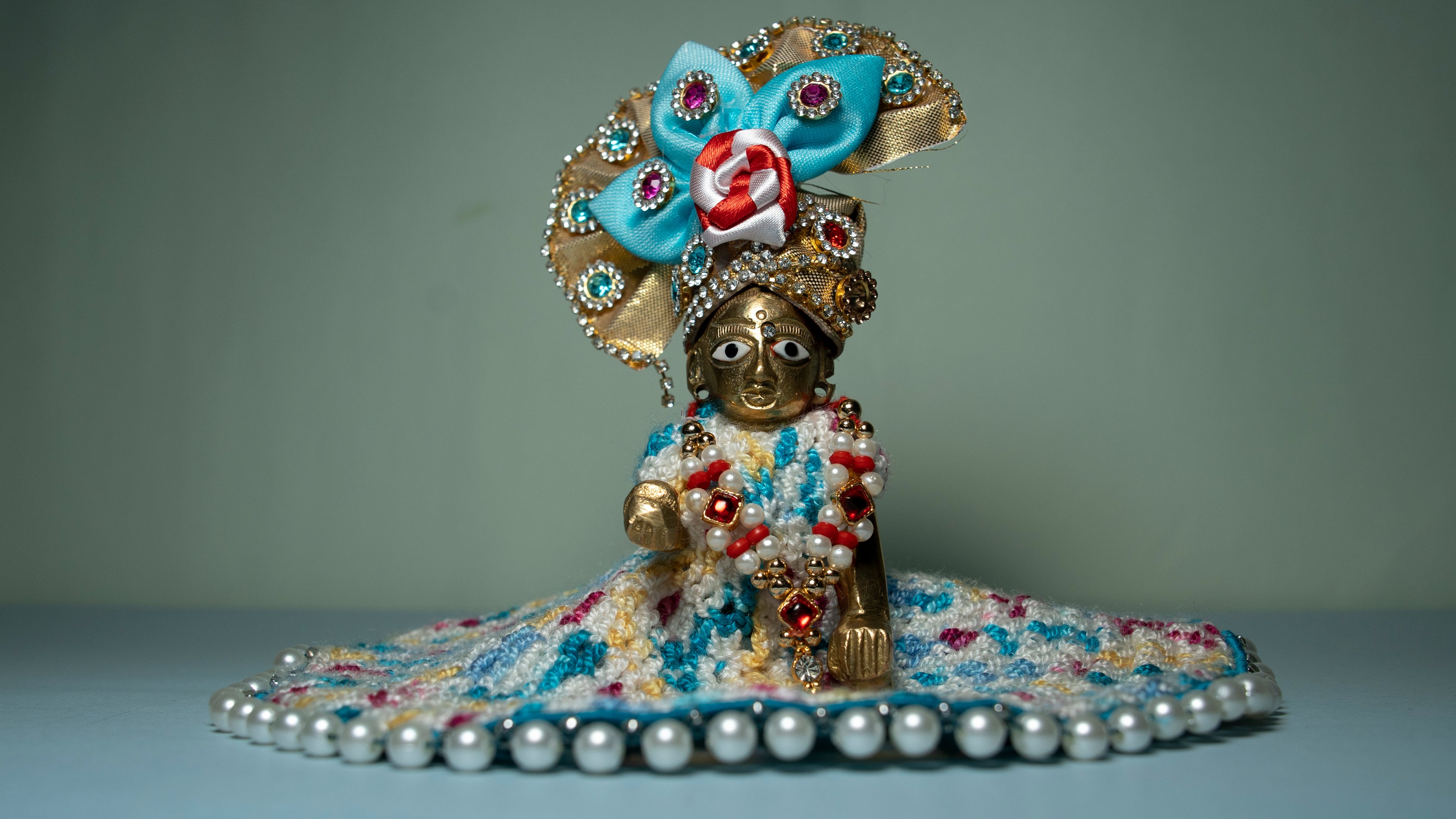 Top view of handcrafted multicolour crochet Poshak for Laddu Gopal with pearl lace border